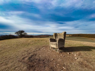 Concrete armchair in the landscape on the hill, village of Morinka, Central Bohemia, Czech Republic clipart