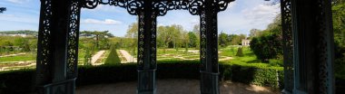 Panoramic of the Rose garden in the Bagatelle park at springtime. Shot from inside the empress kiosk. It is located in Boulogne-Billancourt near Paris, France clipart