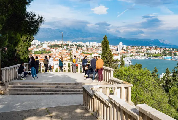 stock image Split, Croatia - May 02 2023: Tourists at the Marjan Hill viewpoint Prva Vidilica na Marjanu to enjoy the view over Splits harbor and city.