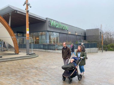 Bracknell, England, U. K. - December 24, 2024: People passing the Waitrose Supermarket in the Lexicon shopping centre, Bracknell, England clipart