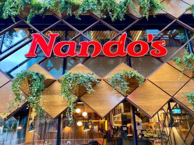 Bracknell, England - January 23, 2025: Nando s is a South African multinational restaurant chain that blends Portuguese and British culture in its food. Especially famous for its Peri Peri Chicken clipart