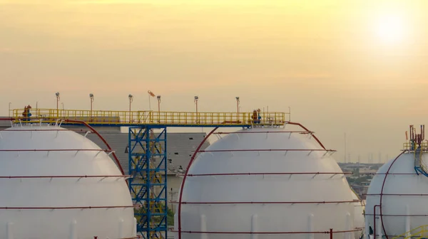 Industrial gas storage tank. LNG or liquefied natural gas storage tank. Round gas tank in petroleum refinery. Natural gas storage industry and global market consumption. Global energy crisis concept.