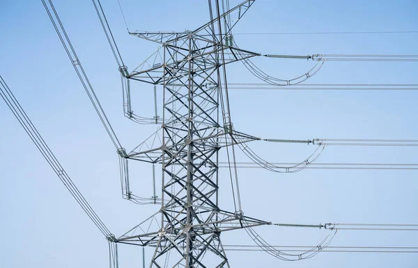 High voltage electric transmission tower. High voltage power lines against the sky. Electricity pylon and electric power transmission lines. High Voltage tower provide power supply. Energy crisis.