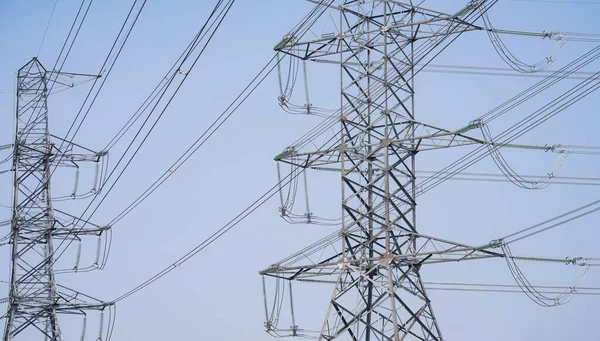High voltage electric transmission tower. High voltage power lines against the sky. Electricity pylon and electric power transmission lines. High Voltage tower provide power supply. Energy crisis.