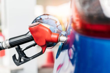 Car fueling at gas station. Refuel fill up with petrol gasoline. Petrol pump filling fuel nozzle in fuel tank of car at gas station. Petrol industry and service. Petrol price and oil crisis concept. clipart