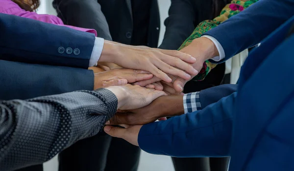Team, teamwork, and unity concept. Diverse team putting hands together. Group of diverse business people. Working together as a team. Partnership and togetherness create a strong sense of community.