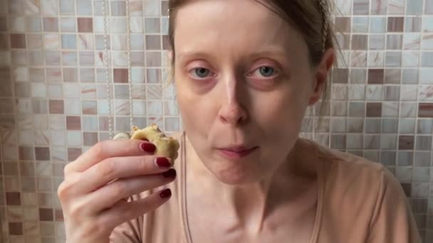 家の中でクッキーを食べる若い女性 — ストック動画