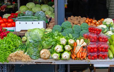 Sokaktaki bir markette taze çiğ organik sebze yığını.