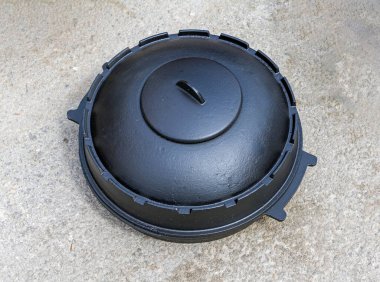 Kapalı kapak dökme demir fırın dışarıda, yerde.