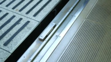 Tren kapısı kapanmak üzereyken tren kapısının alçak açılı görüntüsü istasyonda trene binen insanlar. Japon metro toplu taşımacılığı