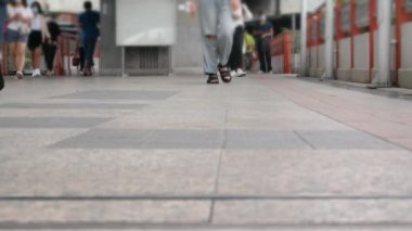 close up view of crowd walking on the walking street day, crowded public space selective focus people feet walk in motion transportation pedestrian