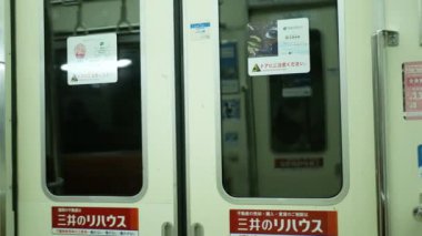 Close up to the train's door while the metro train is moving, in Fukuoka,Japan, Japan Train transportation