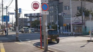 November 15,2022:Fukuoka,Japan:local traffic at intersection street sidewalk in  fukuoka area with sunshine