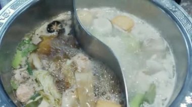 View of boiling hot pot tasty with spicy soup shabu shabu in chinese style with vetgetable in pot. Chinese japanese food dining