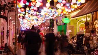 timelapse landscape night view with light illumination on the colonial architecture building with crowded people in Phuket Festival 2023 night time
