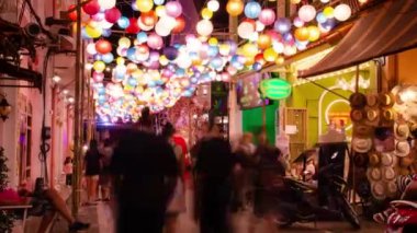 timelapse landscape night view with light illumination on the colonial architecture building with crowded people in Phuket Festival 2023 night time
