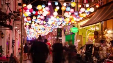 timelapse landscape night view with light illumination on the colonial architecture building with crowded people in Phuket Festival 2023 night time