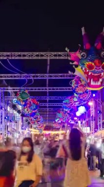 January 27,2023:Phuket old town,Thailand: timelapse landscape night view with light illumination on the colonial architecture building with crowded people in Phuket Festival 2023 night time