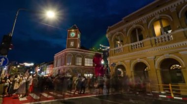 January 27,2023:Phuket old town,Thailand: timelapse landscape night view with light illumination on the colonial architecture building with crowded people in Phuket Festival 2023 night time