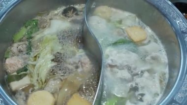 View of boiling hot pot tasty with spicy soup shabu shabu in chinese style with vetgetable in pot. Chinese japanese food dining
