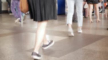 defocused blurred low angle view to feet with crowd of people moving travel on the transition to the metro, defocused blurred background, public transportation in metropolis city