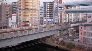 November 15,2022:Fukuoka,Japan:landscape view of the hakata habitat housing building city area with train railway track with sunrise early morning sky