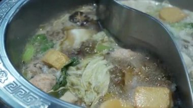 View of boiling hot pot tasty with spicy soup shabu shabu in chinese style with vetgetable in pot. Chinese japanese food dining