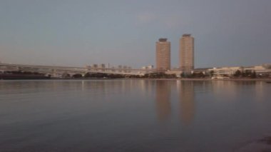 December29,2022:Tokyo,Japan: sunset sky landscape view over tokyo bay area with rainbow bridge and tokyo city in Japan in background, sundown beautiful sky