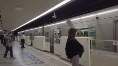 November 15,2022:Fukuoka,Japan: walking view of passenger get off from subway train on track platform in subway station in rush hour