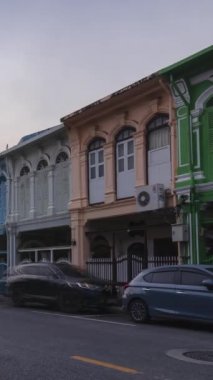 December 28,2022:Phuket old town,Thaialnd: vertical Timelapse landscape view of colonial architecture heritage building with some traffic in sunrise morning daytime