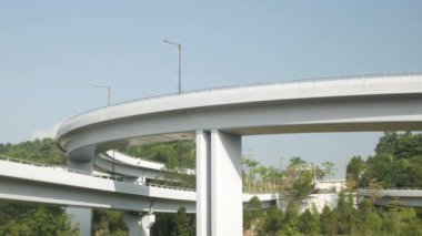 Large concrete crossing highway overhead. Highway crossing under clear blue sky with sunshine daytime, transportation infrastructure transportation