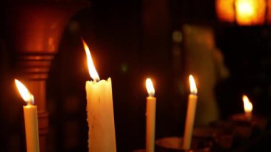 close up minimal view to the candle stick with fire light for praying blessed wish in dark room ,buddhism religion background concept