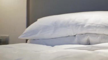 Otel hizmetleri yatak odasına havlu getirir. Yatağın üzerine çiçek koyar.