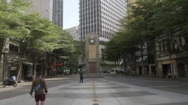 August 16,2022.Kuala lumpur,Malaysia. view at public sqaure with Medan Pasar Clock Tower with some people under sunshine daytime