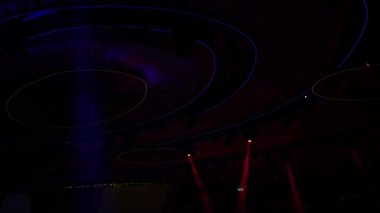 Soyut flaşlı sahne ışığı, sahne ışığı, disko ışığı. Parlak sahne ışıkları, siyah arka plandaki mavi, yumuşak ışık vuruşunda hareket eğlencesi yanıp sönüyor..