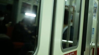Tren hareket halindeyken, Fukuoka, Japonya ve Japonya 'daki tren istasyonuna varana kadar trenin kapısına yakın durun.