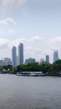 Chaopraya Nehri 'nin dikey zaman çizelgesi. Nehir suyu taşımacılığı ve Bangkok şehrinin arka planı. Gündüz vakti merkez bölge arasında birçok gökdelen var.