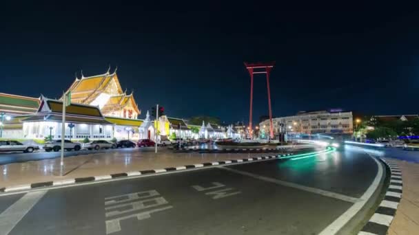 タイのバンコクの有名なランドマーク サットシュタット寺院で夜間にいくつかのトラフィックと街並みを眺めます — ストック動画
