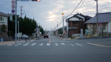 13 Kasım 2022 Fukuoka, Japonya. Gün batımında huzurlu bir ortamda bazı arabalarla yerel trafik kavşağına bakın.
