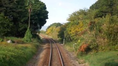 Train journey point of view from on the rear back view of train commuter car Railway Track Seen from Train Perspective POV in japan