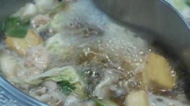 View of boiling hot pot tasty with spicy soup shabu shabu in chinese style with vetgetable in pot. Chinese japanese food dining