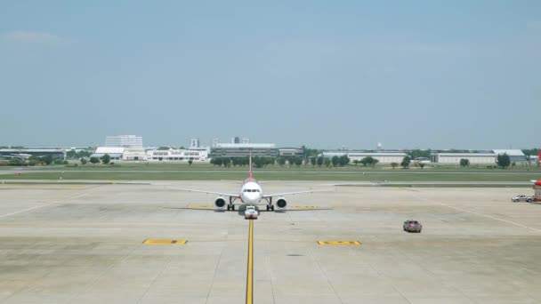 夏休みの昼間の空港からの出発の準備ができている間 飛行機を押すトラックの地上処理サービス 空港の地上操作 — ストック動画