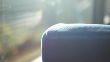 selective focusing view to the seat on the bus while moving up to mountain range hill with sunlight shine through the window,natural travel holiday background