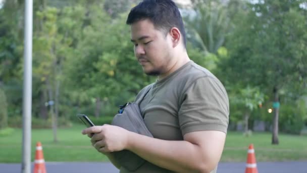 Asian Man Using Mobile Phone While Relaxing Park Using Social — Stock Video