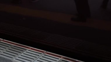 Metro metro istasyonunun alçak açılı görüş platformu. Tren istasyondan hareket ederken, Japonya metro taşımacılığı arka planı.