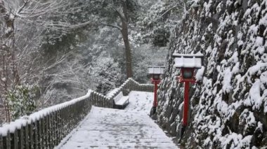 Kyoto dağında karla kaplı kaya merdivenlerinin manzarası. Çam ağacı ormanlarının arasında. Kyoto 'da antik Japon mimari feneri tasarlanmış.