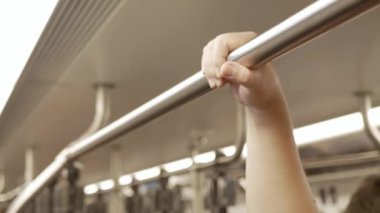 Seçici bir odak noktası ile yakın görünüm metro trenin trabzan tutun şehir toplu taşımacılık. Bir metro içi boş bazı yolcular ile metro trenin içi..