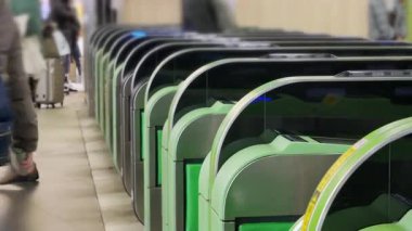 Close up view of the ticket gate in the train station with many passenger get through the ticket gate in rush hour with RFID card in metropolitant big city of Tokyo