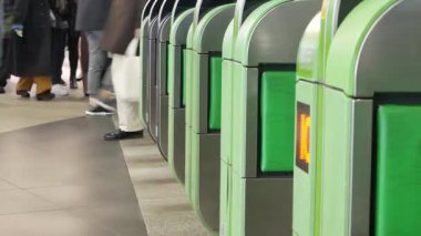 Close up view of the ticket gate in the train station with many passenger get through the ticket gate in rush hour with RFID card in metropolitant big city of Tokyo