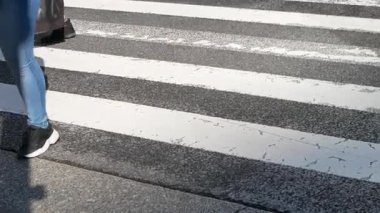 Crowd of pedestrians crossing a city street in low angle view of legs and feet of crowded people society and city life concept in feet lower view closeup around shibuya crossing street road
